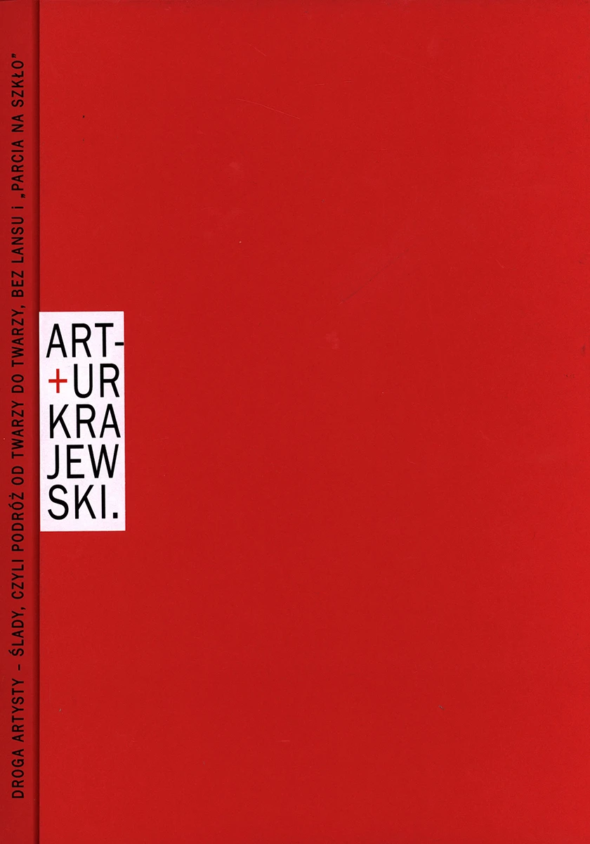 Czerwona okładka z imieniem i nazwiskiem autora publikacji umieszczonym po lewej stronie w białym pionowym prostokącie